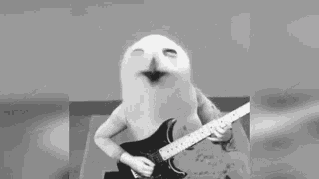 a cartoon character is playing a guitar in a black and white photo .