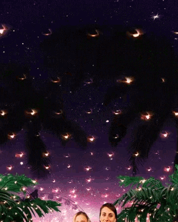 two women are standing in front of a ferris wheel