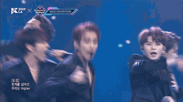 a group of young men are performing on a stage with the words seventeen on the bottom
