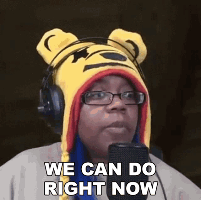 a woman wearing headphones and a winnie pooh hat says we can do right now