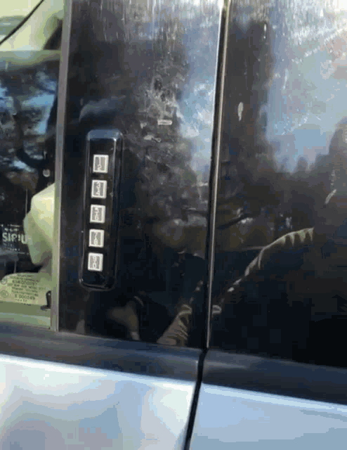a close up of a car door with a sticker that says sachu on it