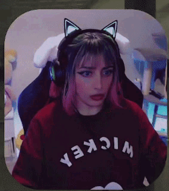 a girl wearing headphones and a shirt that says wickea