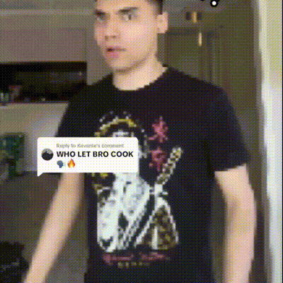 a man wearing a black shirt that says who let bro cook on it