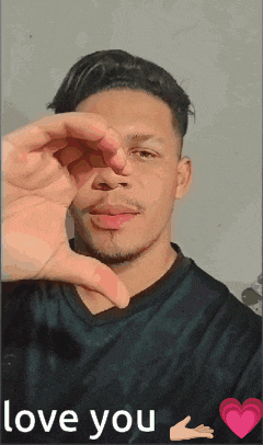 a man is making a heart with his hands and the words love you are below him