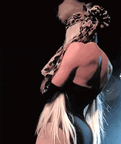 a couple of women are hugging each other on a stage .