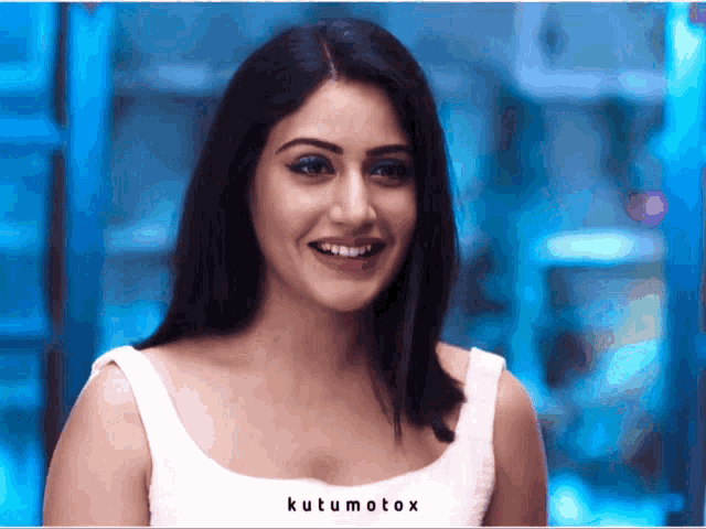 a woman in a white tank top with kutumotox on the bottom