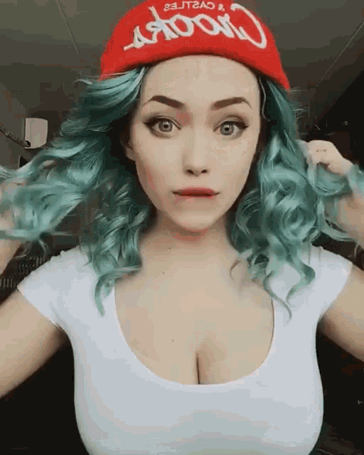 a woman with green hair is wearing a red hat that says crook