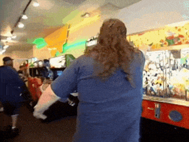 a man in a blue shirt is playing a video game