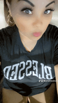 a woman wearing a t-shirt that says ' t223.j9 ' on it