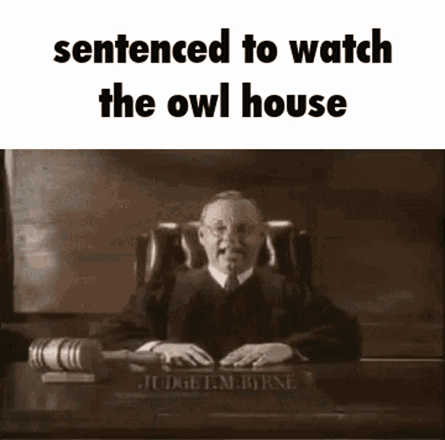 a judge is sitting at a desk in a courtroom holding a gavel and sentenced to watch the owl house .