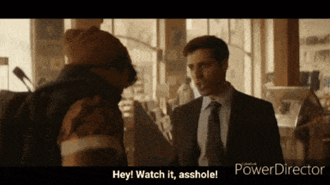 a man in a suit and tie talking to another man with the words hey watch it asshole on the screen