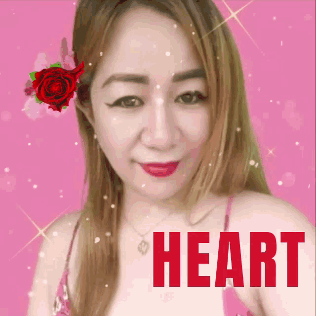 a woman with a red rose in her hair and the word heart on her chest