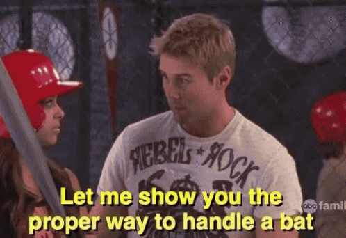 a man wearing a rebel rock shirt talks to a woman