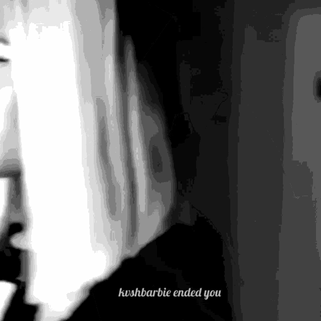 a black and white photo of a woman standing in front of a window with the words kashbarbie ended you written on the bottom