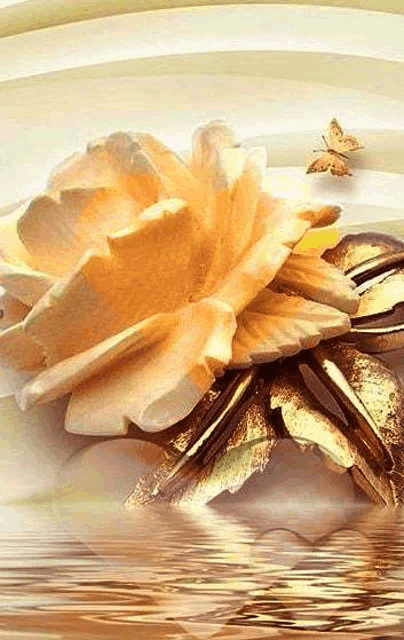 a large yellow flower with gold leaves is sitting on top of a table next to water .