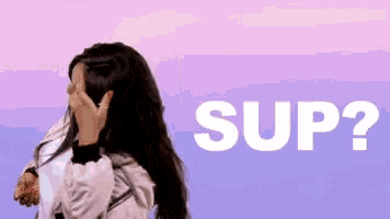 a woman covering her face in front of the word sup ?
