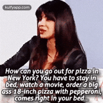 a woman is sitting on a couch talking about pizza .