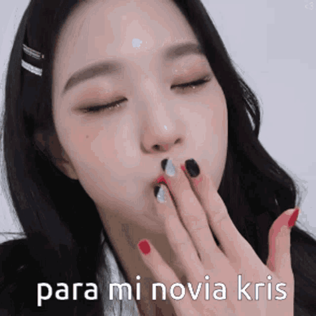 a close up of a woman blowing a kiss with the words para mi novia kris written below her