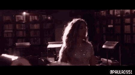 a woman in a white dress is dancing in a library with the hashtag paula091