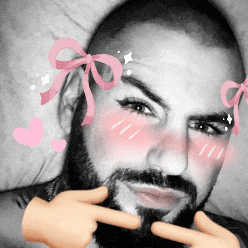 a man with a beard has pink bows on his head