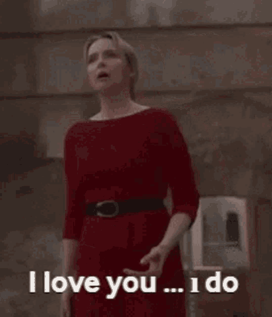 a woman in a red dress is saying i love you