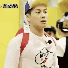 a man wearing a pink shirt and a purple hat