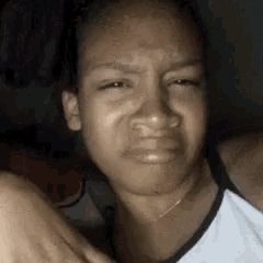 a close up of a woman making a funny face .