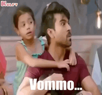 a man is holding a little girl in his arms and the little girl is looking at the camera .
