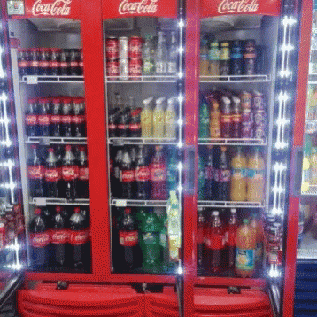 a coca cola refrigerator filled with lots of drinks
