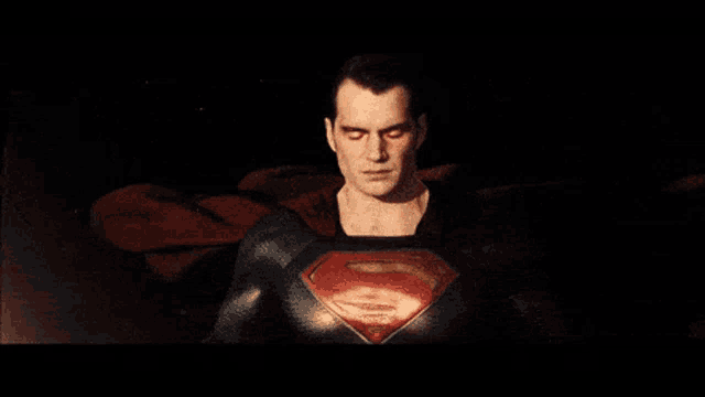 a close up of superman 's face with his eyes lit up
