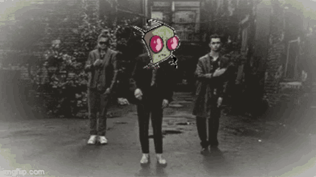 a group of men are standing in a dark alleyway with a cartoon character on their face .