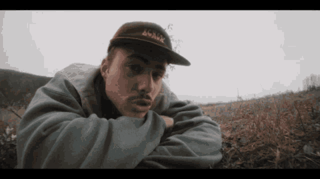 a man wearing a hat that says shark is laying down