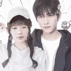 a man and a woman are posing for a picture together . the woman is wearing pigtails and a hat .