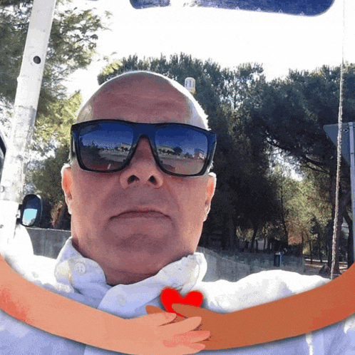 a man wearing sunglasses is surrounded by trees
