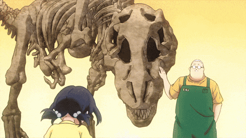 a man in a green apron stands next to a skeleton