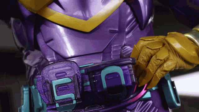 a person wearing a purple and yellow costume with a belt that has the number 50 on it