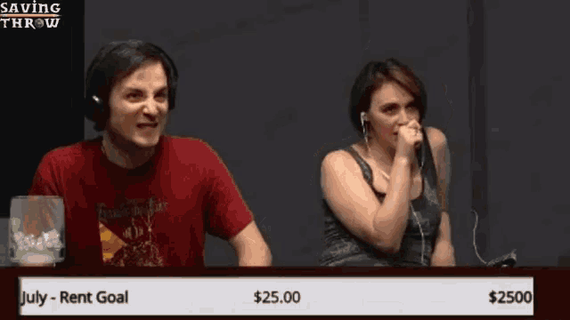 a man and a woman are sitting in front of a saving throw screen