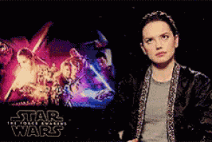 a woman is standing in front of a poster for star wars