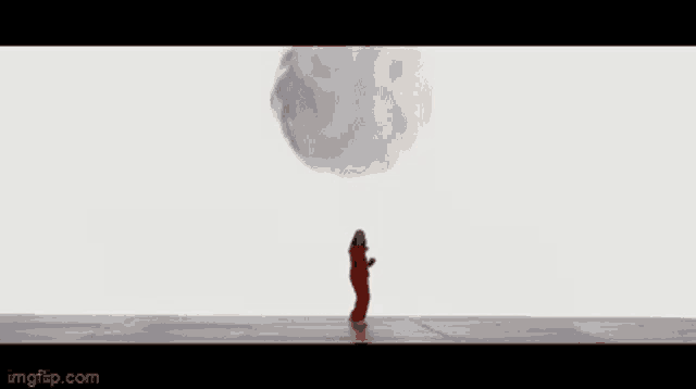 a woman in a red dress is standing in front of a white cloud .