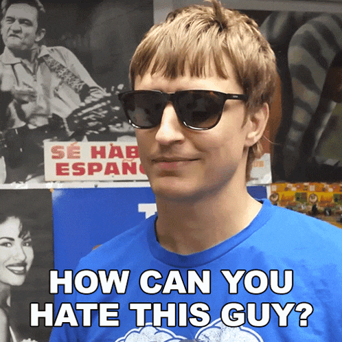 a man wearing sunglasses and a blue shirt with the words how can you hate this guy
