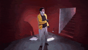 a man in a yellow shirt is walking up stairs
