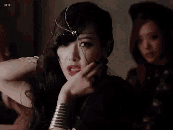 a woman with a ring on her finger and a bracelet on her wrist