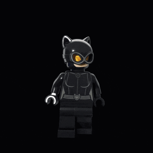 a lego figure of a catwoman with yellow eyes and ears