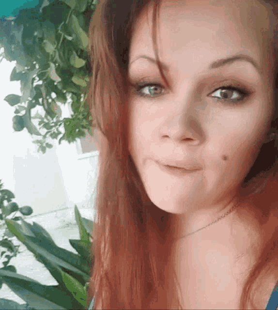 a close up of a woman 's face with green eyes
