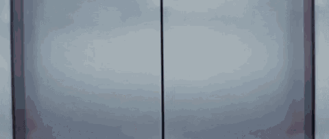 a painting of thanos ' face is peeking out of a door .