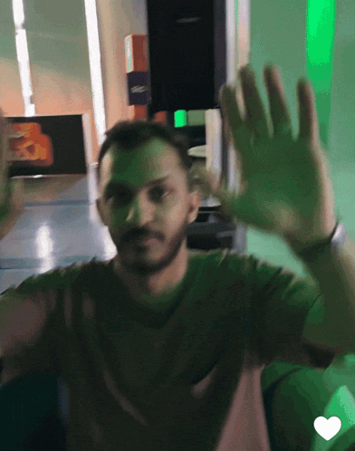 a man in a brown shirt is waving his hands in front of a sign that says gmc