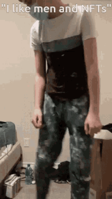 a man wearing a mask is dancing in a room with the words " i like men and nfts " on the bottom