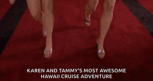 karen and tammy are walking down a red carpet holding hands .