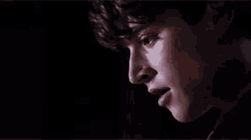 a close up of a man 's face with a tear coming out of his eye .