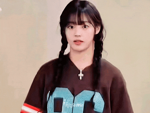 a girl with braids is wearing a t-shirt that says dc on it
